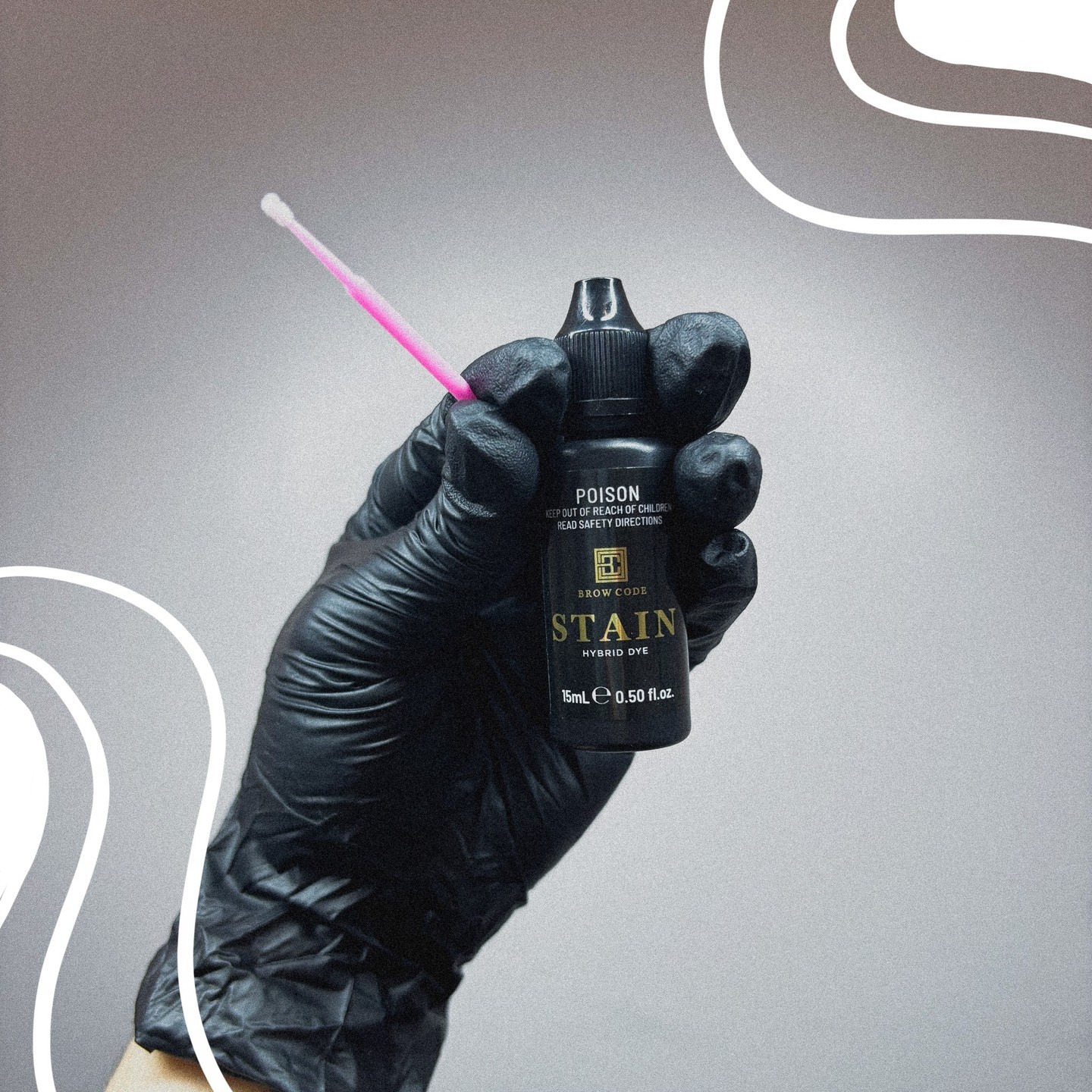 Gloved hand holding a bottle of hybrid dye stain with applicator brush